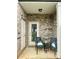 Cozy patio featuring a brick wall, outdoor seating, and decor, creating a welcoming entrance at 1205 Skywatch Ln, Monroe, NC 28112