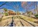 Expansive backyard with a firepit, white fence, palm trees, and a deck overlooking the outdoor space at 125 Rocky Trail Ct, Fort Mill, SC 29715
