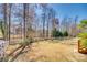 Beautiful backyard with well-maintained lawn, white fencing, mature trees and a partial view of the house at 125 Rocky Trail Ct, Fort Mill, SC 29715
