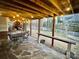 Spacious covered patio featuring stone flooring and outdoor dining under warm string lights at 125 Rocky Trail Ct, Fort Mill, SC 29715