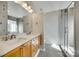 Bright bathroom with double sinks, a shower with glass door, a tile floor and a large mirror at 125 Rocky Trail Ct, Fort Mill, SC 29715