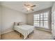 Bedroom with a ceiling fan, a bed with a striped comforter, carpet and a window at 125 Rocky Trail Ct, Fort Mill, SC 29715