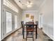 Bright dining area with a table for six, tile flooring, and a double door to the backyard at 125 Rocky Trail Ct, Fort Mill, SC 29715