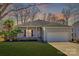 Charming single-story home with a well-manicured lawn, complemented by a two-car garage and inviting front porch at 125 Rocky Trail Ct, Fort Mill, SC 29715