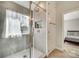 Modern shower featuring a tiled walls, a showerhead, a window, and a glass door at 125 Rocky Trail Ct, Fort Mill, SC 29715