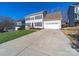 Traditional home with a two-car garage, a well manicured lawn, and a long concrete driveway at 12642 Cardinal Woods Dr, Pineville, NC 28134