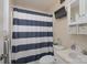 This bathroom features a vanity with solid surface top, toilet, and a shower-tub combo with striped shower curtain at 142 Westerwood Dr, Rock Hill, SC 29732