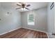 Comfortable bedroom with wood-look floors, a ceiling fan, and a large window at 142 Westerwood Dr, Rock Hill, SC 29732