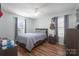This bedroom features a bed with neutral bedding, plank flooring, and a window for natural lighting at 142 Westerwood Dr, Rock Hill, SC 29732