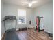 This exercise room features plank flooring, a ceiling fan, and workout equipment and weights at 142 Westerwood Dr, Rock Hill, SC 29732