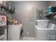 Organized laundry room featuring a washer, dryer, water heater, and storage shelves at 142 Westerwood Dr, Rock Hill, SC 29732