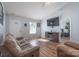Cozy living room with modern flooring, plush sofa, mounted television, and natural light at 142 Westerwood Dr, Rock Hill, SC 29732