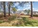 Expansive backyard with a wooden deck, fire pit, and mature trees, perfect for outdoor entertaining and relaxation at 148 Painted Bunting Dr, Troutman, NC 28166
