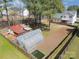 The aerial view shows greenhouses, a pond, and the home's backyard with a fire pit and a garden at 148 Painted Bunting Dr, Troutman, NC 28166