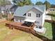 Aerial view showcases the wooden deck, manicured landscaping, and fenced yard for privacy and enjoyment at 148 Painted Bunting Dr, Troutman, NC 28166