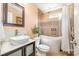 A bathroom featuring bathtub, toilet, sink, and a window at 148 Painted Bunting Dr, Troutman, NC 28166