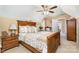 A large primary bedroom with carpeted floors, a ceiling fan, and a door leading to another room at 148 Painted Bunting Dr, Troutman, NC 28166