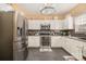 Bright kitchen with stainless steel refrigerator and double oven and lots of countertop space for food prep at 148 Painted Bunting Dr, Troutman, NC 28166
