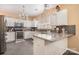 Well-lit kitchen features white cabinets, stainless steel appliances, granite countertops and a stylish backsplash at 148 Painted Bunting Dr, Troutman, NC 28166