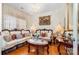 Elegant living room with luxurious seating, chandelier, and hardwood flooring at 148 Painted Bunting Dr, Troutman, NC 28166