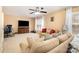 Spacious living room featuring a ceiling fan, neutral carpeting, and lots of natural light at 148 Painted Bunting Dr, Troutman, NC 28166