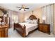 Elegant main bedroom with a large, ornate bed, dark wood furnishings, and soft lighting at 148 Painted Bunting Dr, Troutman, NC 28166