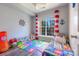 Playful ' bedroom with colorful decor, large window, and wood flooring at 14941 Santa Lucia Dr, Charlotte, NC 28277