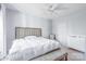 Bright bedroom featuring neutral walls, ceiling fan, and a comfortable upholstered headboard at 14941 Santa Lucia Dr, Charlotte, NC 28277