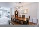 Modern dining room with stylish lighting and wood floors, open to the living area at 14941 Santa Lucia Dr, Charlotte, NC 28277