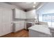 Bright kitchen featuring white countertops, stainless steel appliances, and laminate floors at 14941 Santa Lucia Dr, Charlotte, NC 28277