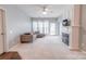 Spacious living room with a fireplace, carpet flooring, and lots of natural light at 14941 Santa Lucia Dr, Charlotte, NC 28277
