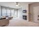Spacious living room with a fireplace, carpet flooring, and lots of natural light at 14941 Santa Lucia Dr, Charlotte, NC 28277