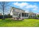 Home's backyard with a fire pit area and covered patio, ideal for outdoor entertaining at 15307 Country Lake Dr, Pineville, NC 28134