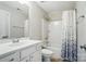 Bright bathroom featuring a vanity, toilet, and shower with a patterned shower curtain at 15307 Country Lake Dr, Pineville, NC 28134