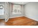 Bedroom with hardwood floors, gray walls, and a window at 15307 Country Lake Dr, Pineville, NC 28134