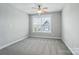 Neutral bedroom with carpet, light gray walls, and a ceiling fan at 15307 Country Lake Dr, Pineville, NC 28134