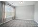 A bright bedroom features neutral walls, a window with blinds, and plush carpeting at 15307 Country Lake Dr, Pineville, NC 28134