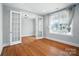 Bright bedroom featuring hardwood floors and large windows at 15307 Country Lake Dr, Pineville, NC 28134
