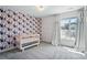 Bright Bedroom with colorful accent wall, a crib, and a window offering natural light at 15307 Country Lake Dr, Pineville, NC 28134