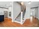 Bedroom with hardwood floors, a staircase and white trim at 15307 Country Lake Dr, Pineville, NC 28134
