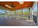 Covered deck with wood ceilings and flooring, ceiling fan, and outdoor heater with views of the backyard and trees at 15307 Country Lake Dr, Pineville, NC 28134