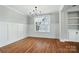 Bright dining room with hardwood floors, white trim, and a modern chandelier and built in shelving at 15307 Country Lake Dr, Pineville, NC 28134