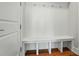Hall tree with bench seating, hooks, and white painted trim at 15307 Country Lake Dr, Pineville, NC 28134