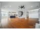 Spacious living room featuring hardwood floors, an open staircase, and a view into a modern kitchen at 15307 Country Lake Dr, Pineville, NC 28134
