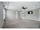 Neutral-toned bedroom with plush carpet and a view into the spa-like ensuite bathroom at 15307 Country Lake Dr, Pineville, NC 28134