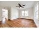 Bedroom with hardwood floors, ceiling fan, and ample natural light at 1865 Woodland Dr, Charlotte, NC 28205