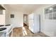 Bright kitchen features tile floors, window, and white refrigerator at 1865 Woodland Dr, Charlotte, NC 28205