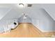 Spacious attic with hardwood floors, dormer window, ceiling fan, neutral walls, and couch at 1919 46Th Avenue Ne Dr # 46, Hickory, NC 28601