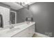 Bathroom featuring double vanity, large mirror, and gray paint at 1919 46Th Avenue Ne Dr # 46, Hickory, NC 28601