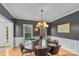 Sophisticated dining room featuring hardwood floors, wainscoting, and a modern chandelier above an oval dining table at 1919 46Th Avenue Ne Dr # 46, Hickory, NC 28601